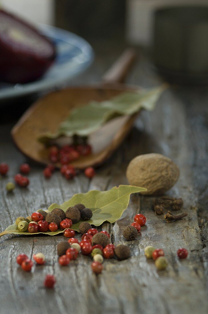 An arrangement of allspice, peppercorn, bay leaves, nutmeg and cloves