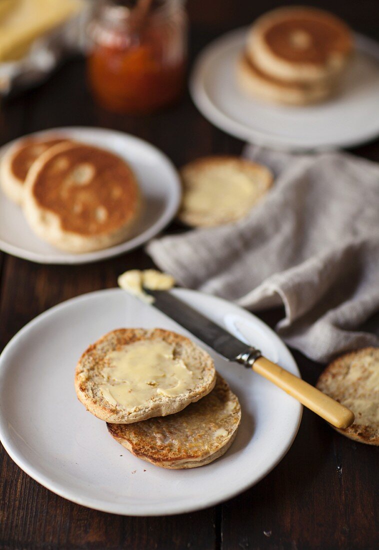 A toasted English muffin spread with butter