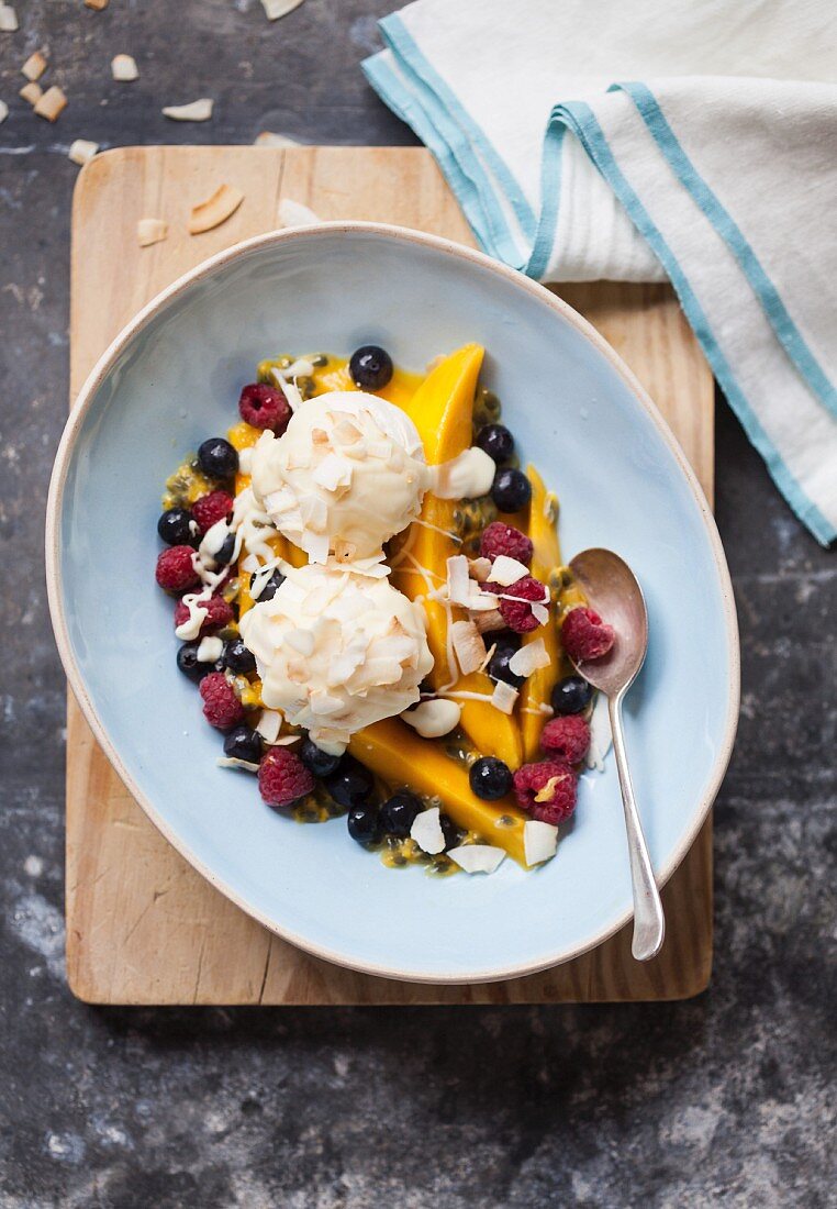 Vanilla ice cream on exotic fruit salad with coconut chips