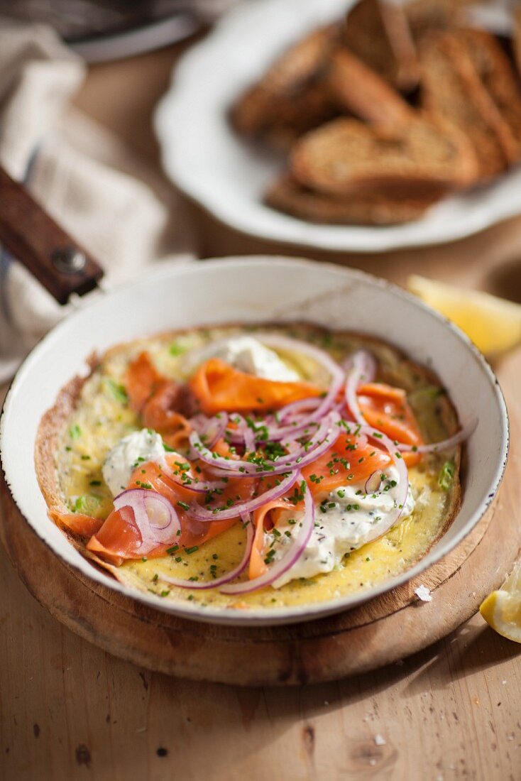 Omelette with smoked salmon in a pan