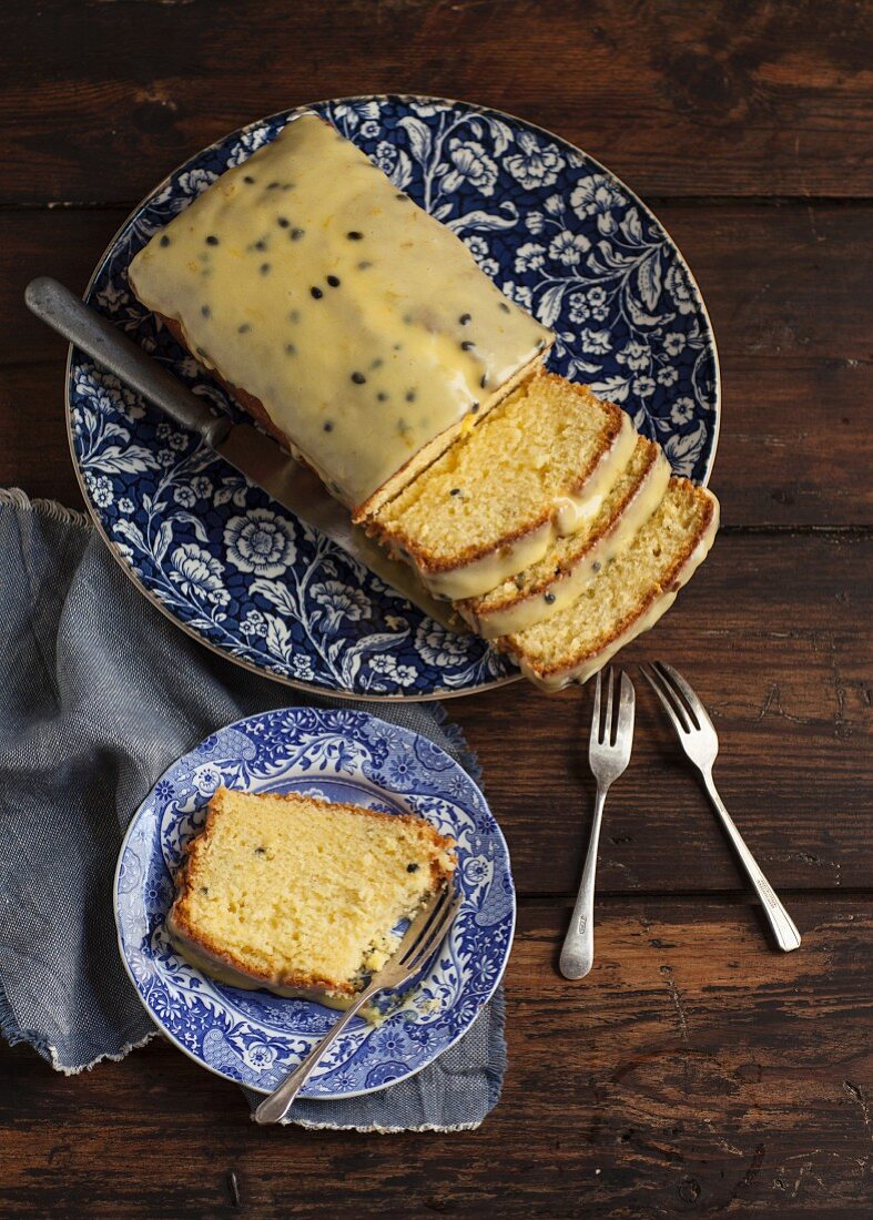 Passion fruit cake with a sugar glaze with a slice on a plate