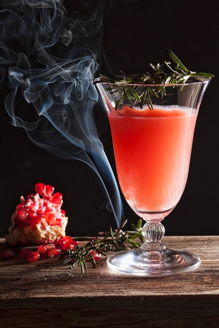 A pomegranate cocktail with rosemary