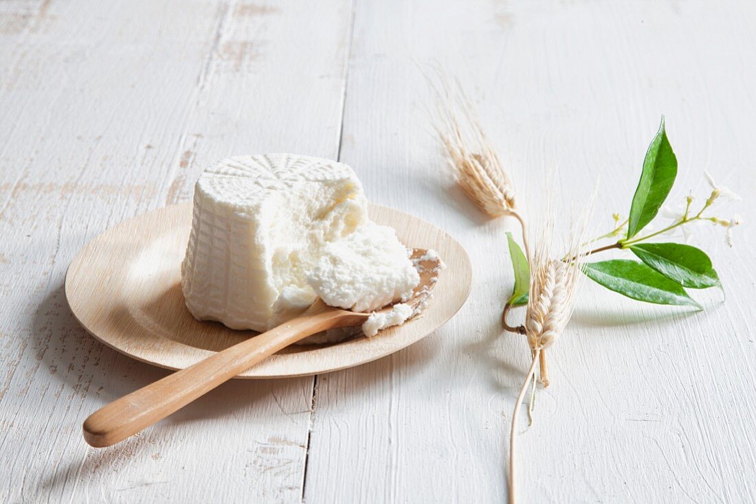 Ricotta on a plate with a wooden spoon