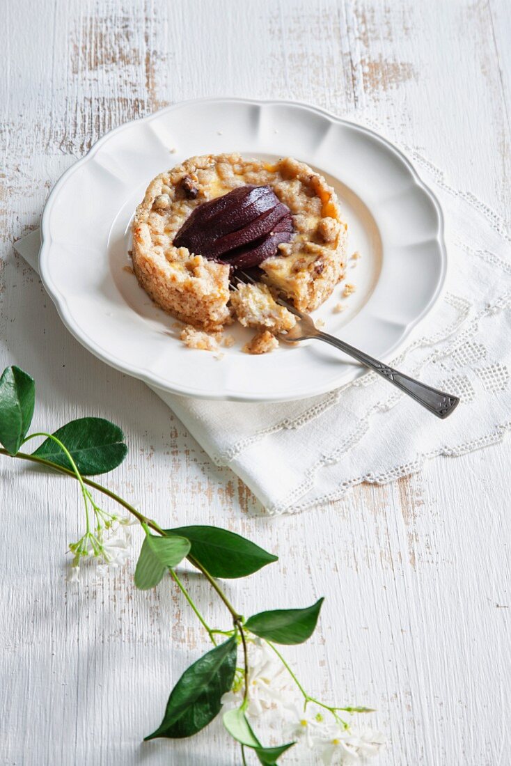 Ricotta crumble tart with a red wine pear