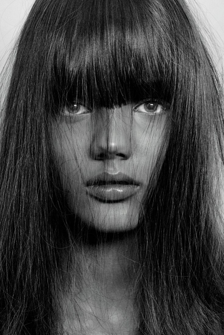 Young woman with brown hair and blue eyes, close-up (black and white photo)