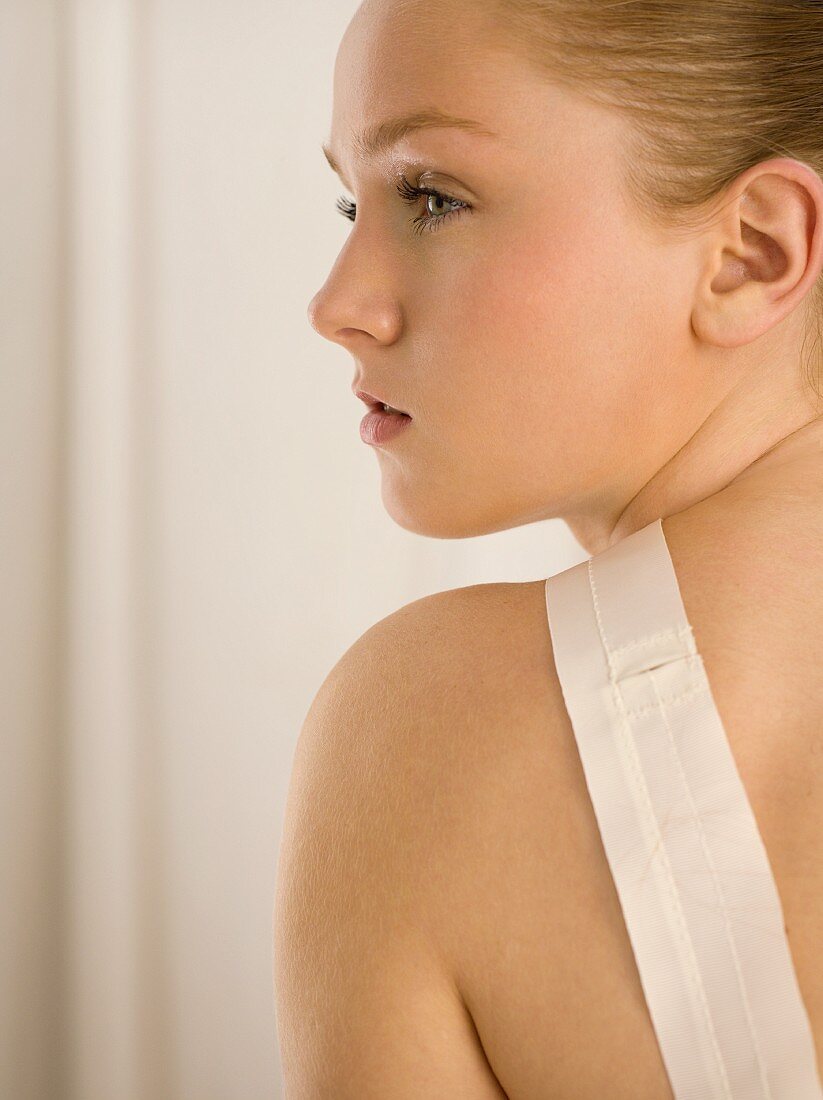 Young blonde woman wearing top with straps