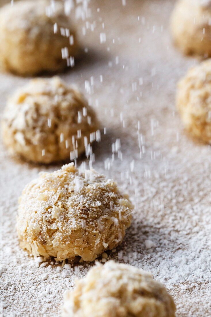 Icing sugar being sprinkled over oat bites