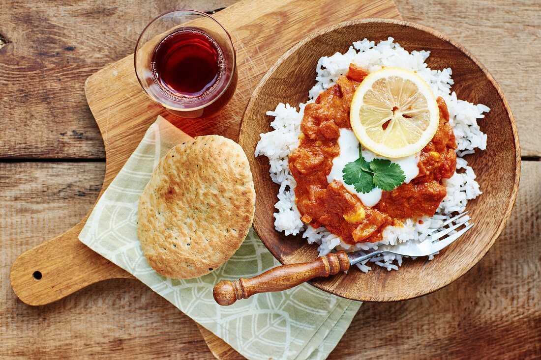 Seitan tikka masala on a bed of rice with soya yoghurt and paratha (India)