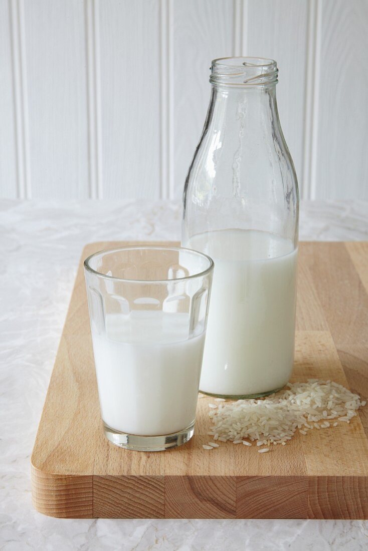 Vegan rice milk in a glass and in a bottle