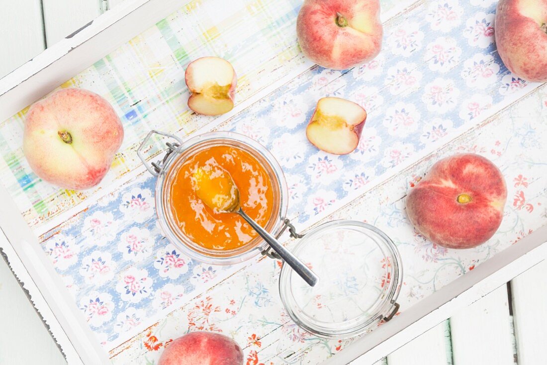 Homemade peach jam made from vineyard peaches on a tray (seen from above)