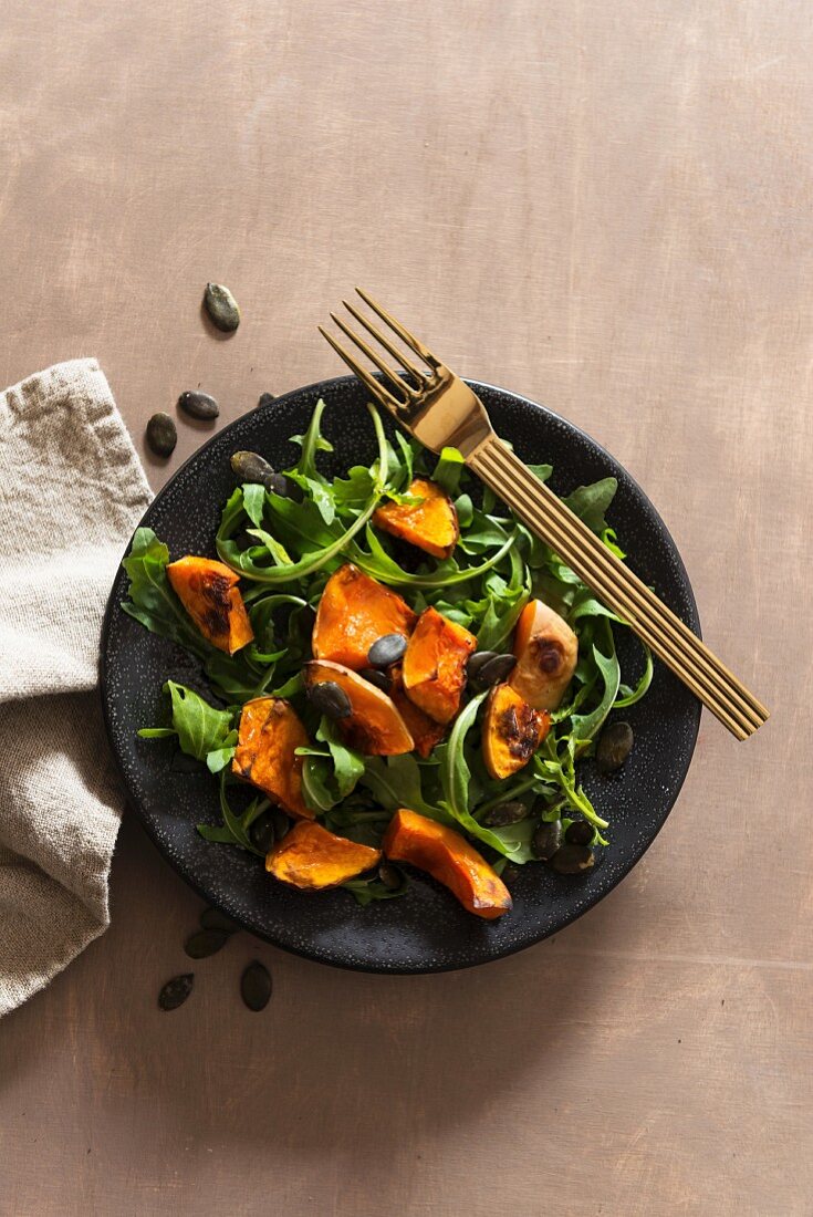 Rocket salad with winter squash and pumpkin seeds