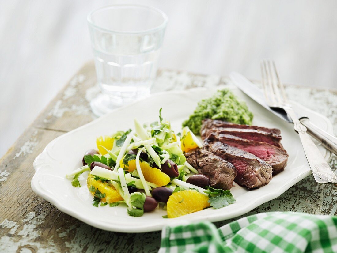 Beef steak with broccoli purée and a salad with orange fillets