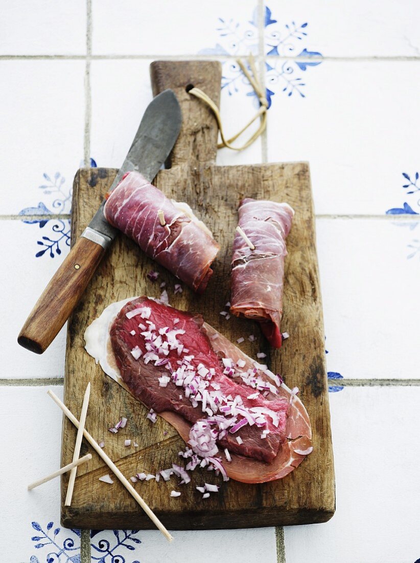 Raw beef roulade with ham and chopped onions
