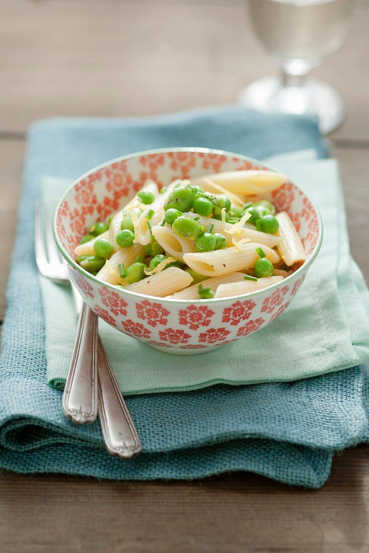 Penne pasta with broad beans and peas