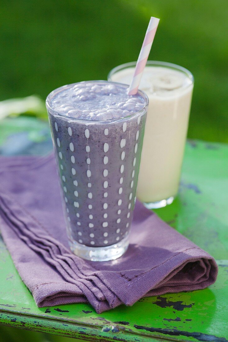 A blueberry and oat smoothie and a banana smoothie