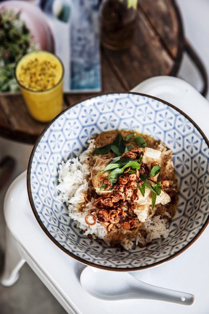 Yellow fish curry on rice with turmeric-rose water lassi