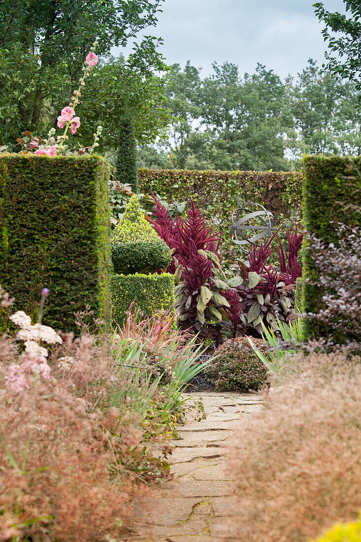 Juxtaposition of topiary and informal planting in garden