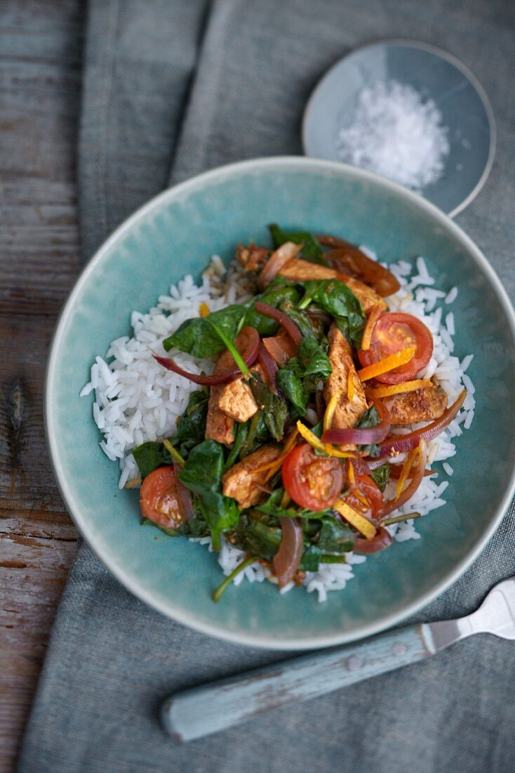Pork with balsamic vinegar, tomatoes and basil on a bed of rice