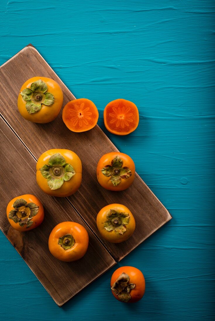 Persimmons, whole and halved