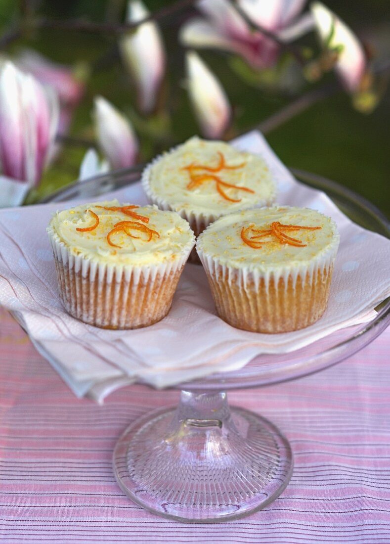 Pumpkin cupcakes with oranges on a cake stand