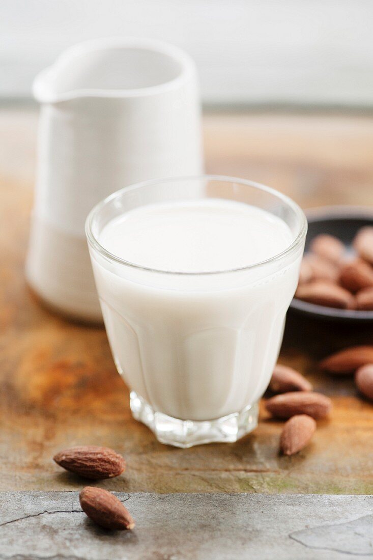 A glass of almond milk and almonds