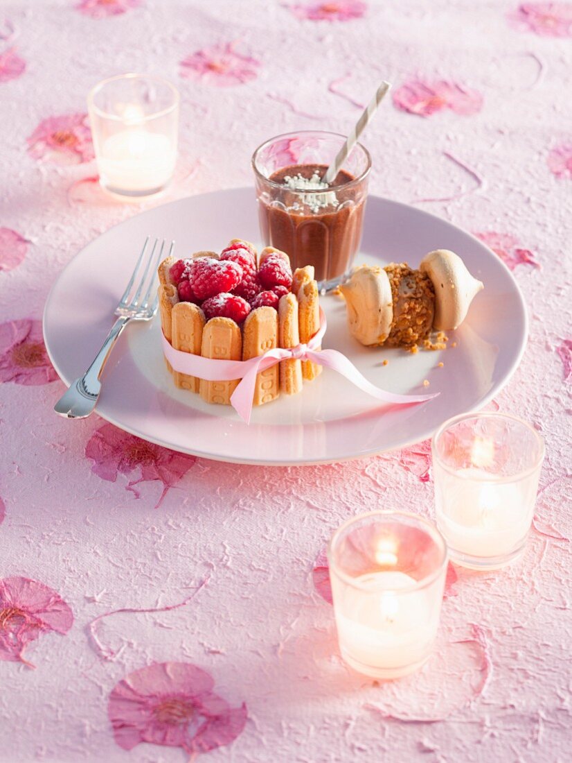 A Christmas dessert platter with a mini ice cream Charlotte, ice cream meringues and chocolate ice cream shake