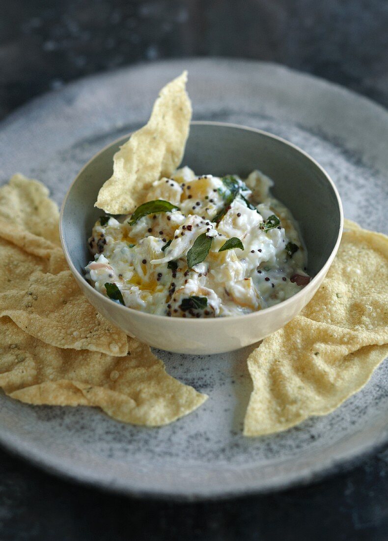 Yoghurt with pineapple, herbs and popadoms (India)