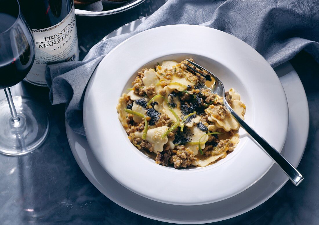 Pasta medallions with meat ragout and poppy seeds