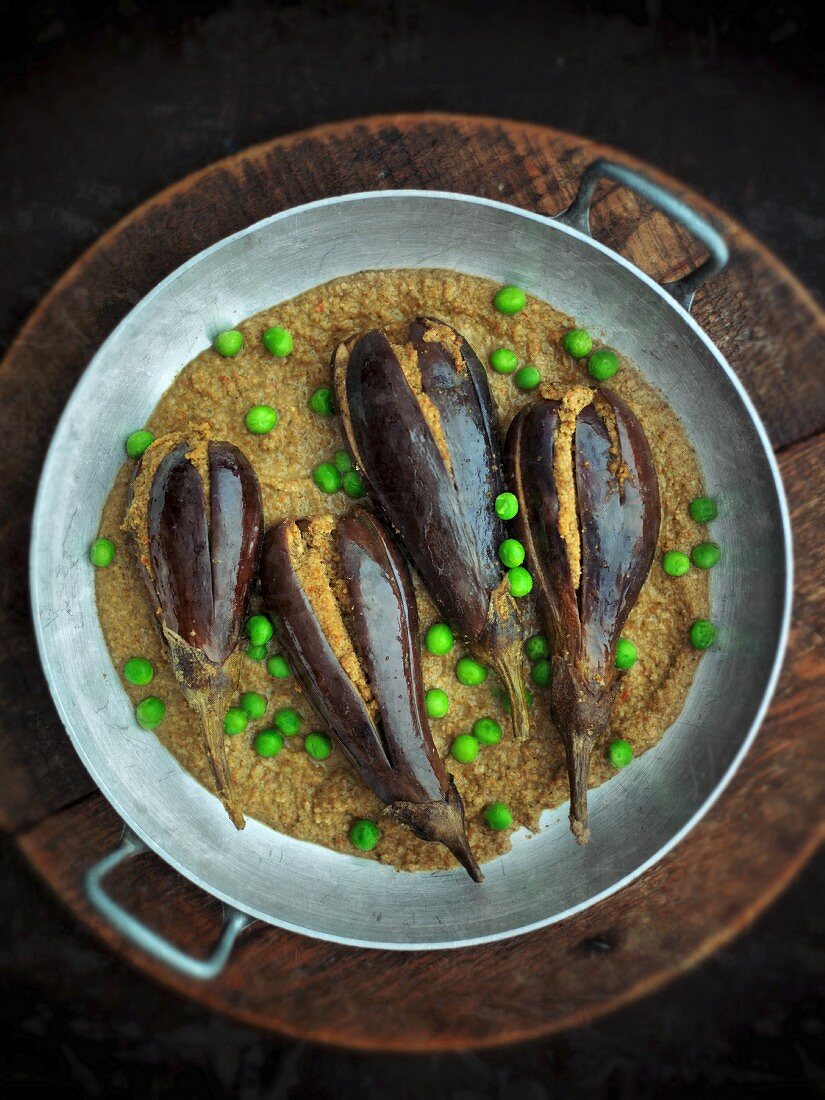 Stuffed aubergines with peas on a lentil purée