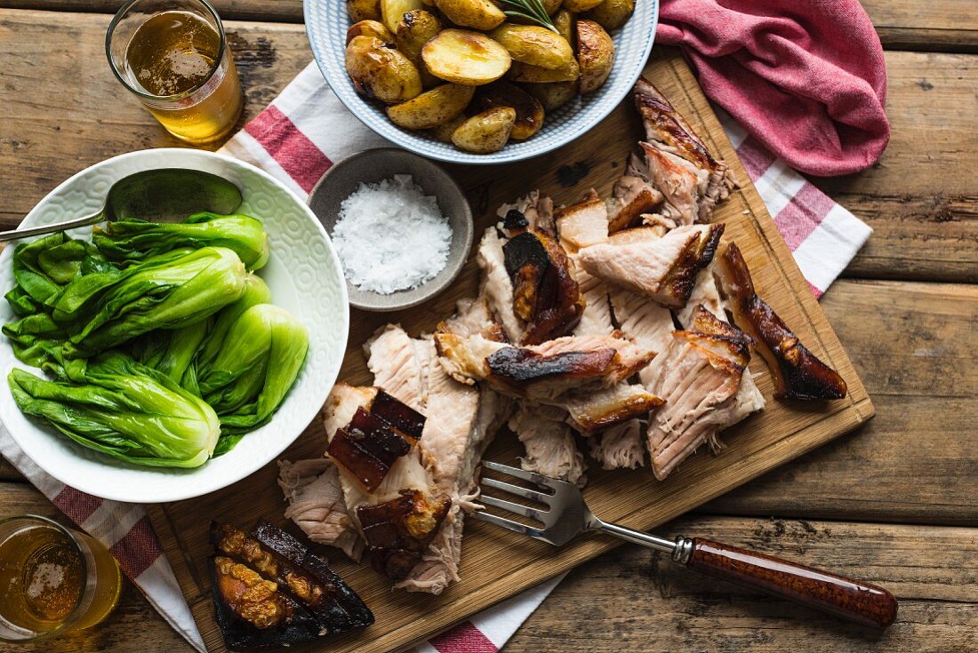 Roasted pork belly with rosemary potatoes, bok choy and beer