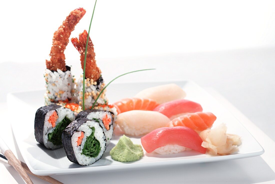 Various types of sushi on a white plate