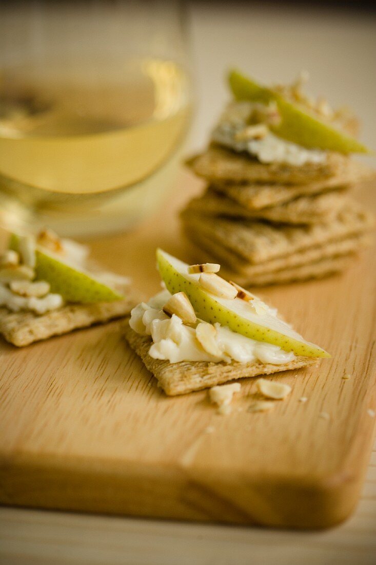 Crackers topped with soft cheese, care and almonds