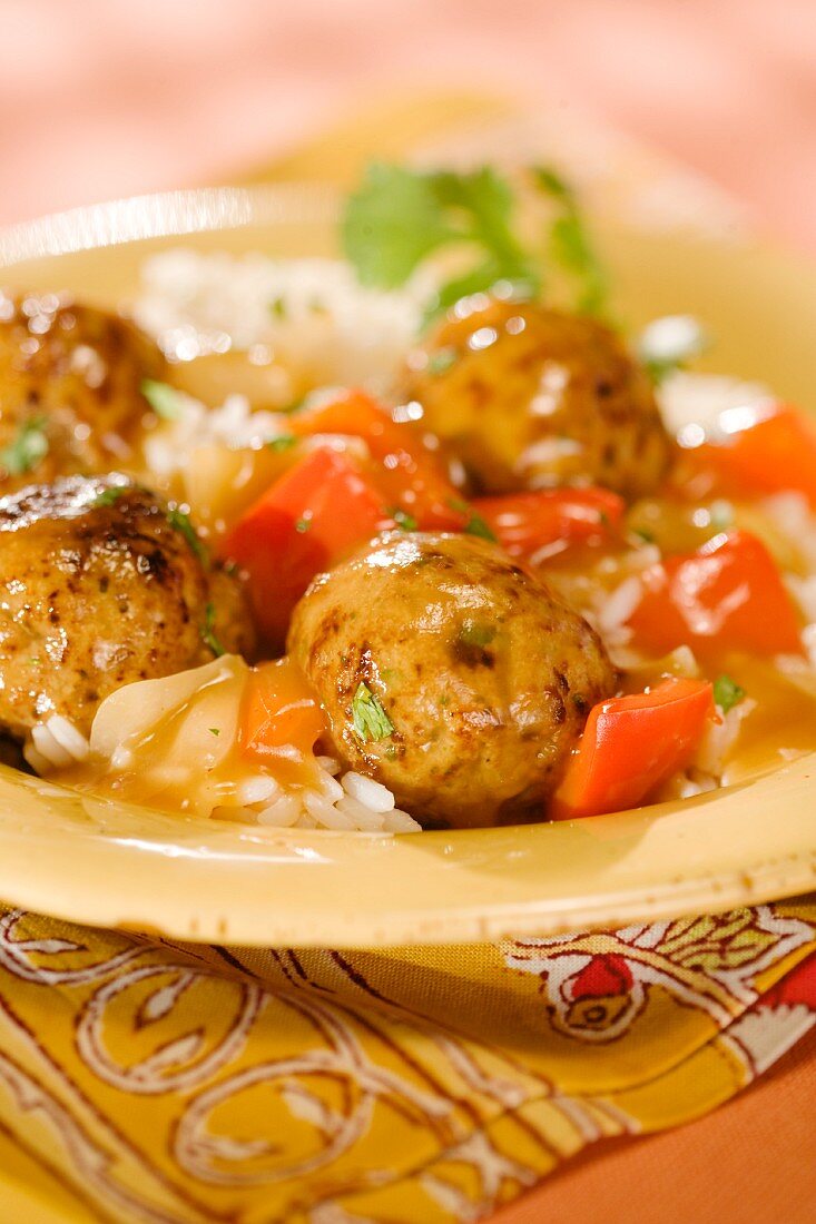 Turkey meat balls in a vegetable sauce on a bed of rice