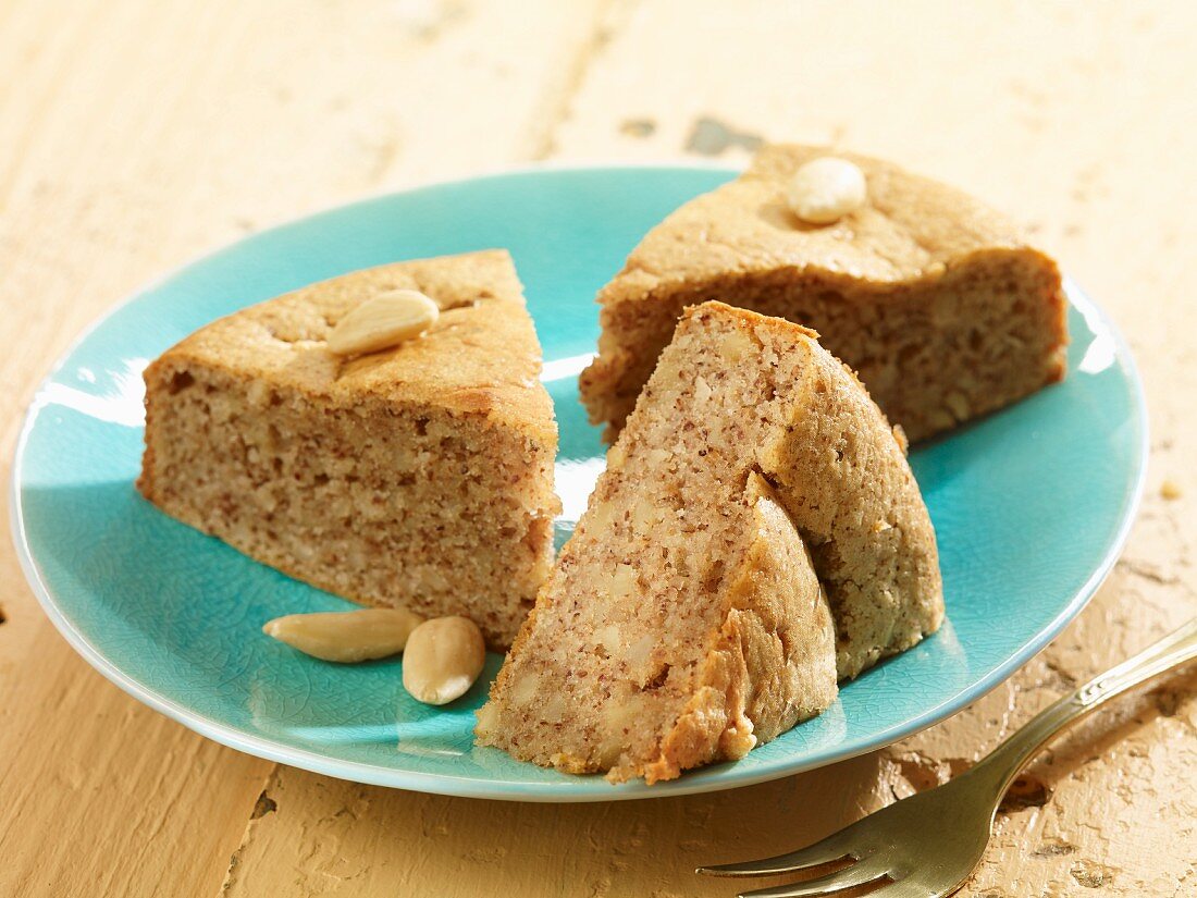 Three slices of almond cake on a plate
