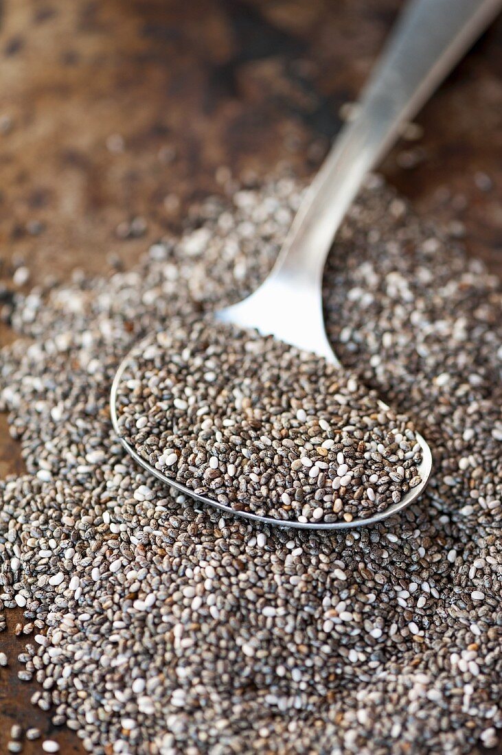 A pile of chia seeds with a spoon