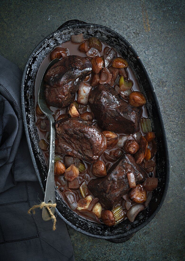 Venison in a red wine sauce with chestnuts and vegetables