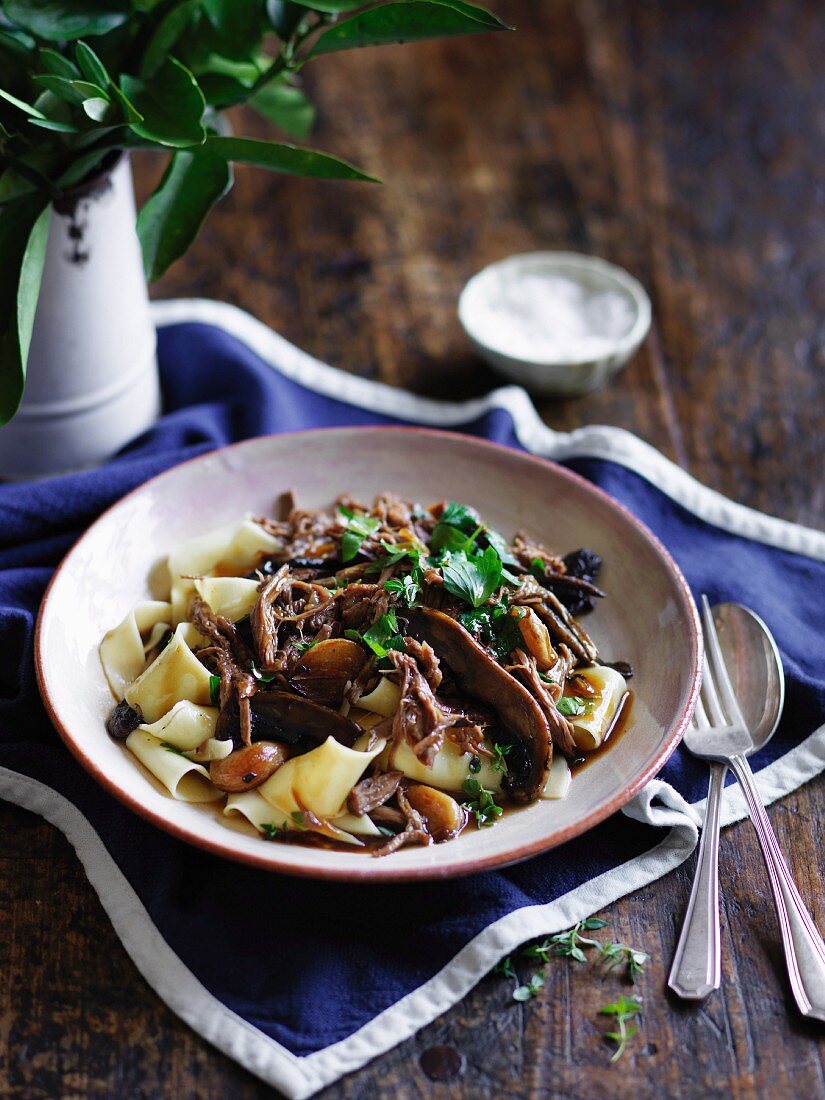 Beef leg with roasted garlic on pappardelle