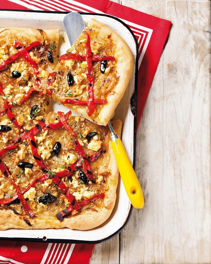 Pissaladiere with onions, peppers, olives, herbs and feta cheese