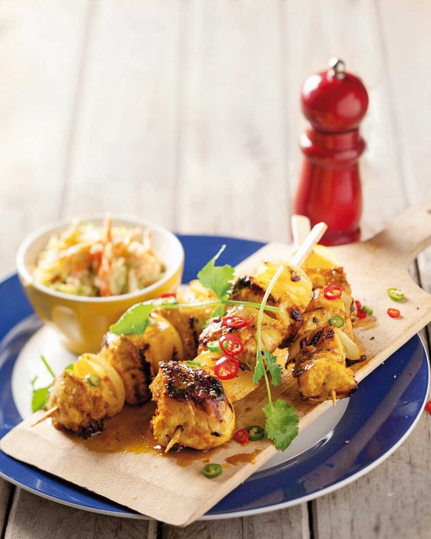 Spicy chicken and pineapple skewers with coconut coleslaw