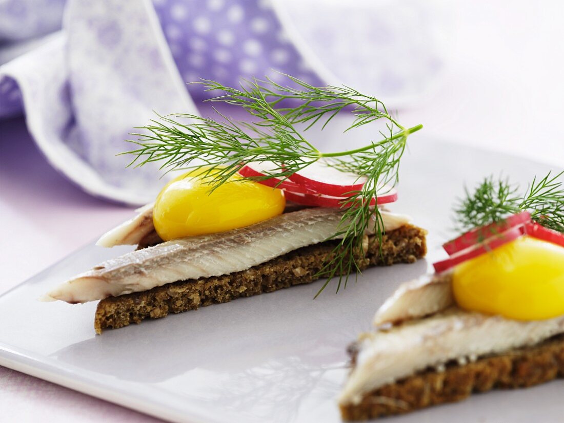 Smorrebrod top with herring and radishes