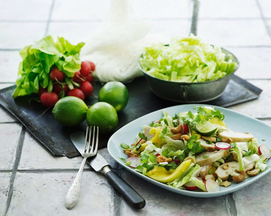 Iceberg lettuce with chicken, peppers, relishes and cashew nuts
