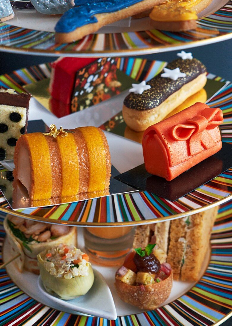 Sandwiches and sweet pastries on a cake stand for teatime (close-up)