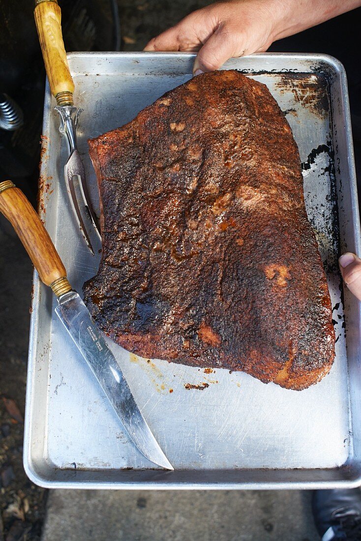 Smoked beef brisket on a baking tray