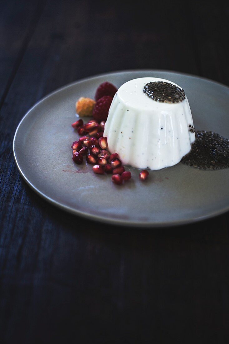 Panna cotta with chia seeds, pomegranate and raspberries