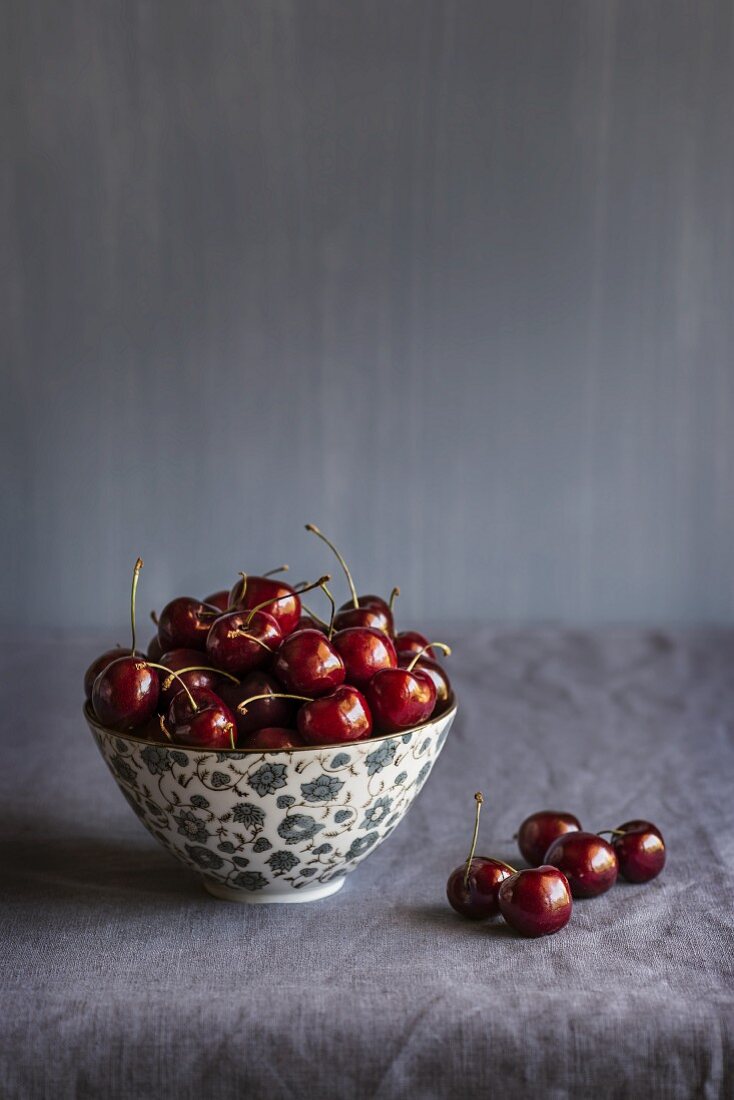 Cherries in a bowl and next to it