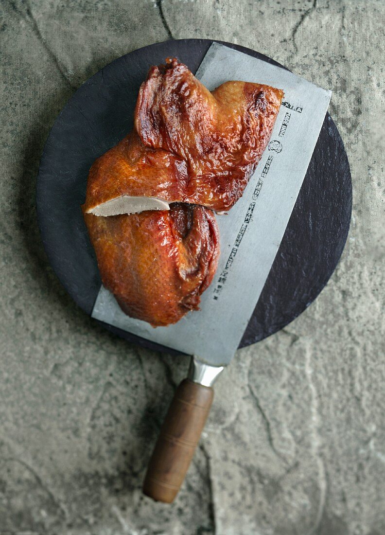 Roasted duck on a meat cleaver (China)