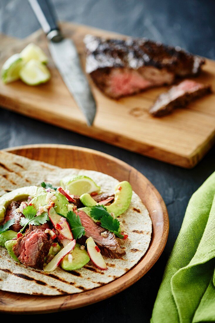 Tortillas with avocado salad and grilled beef steak