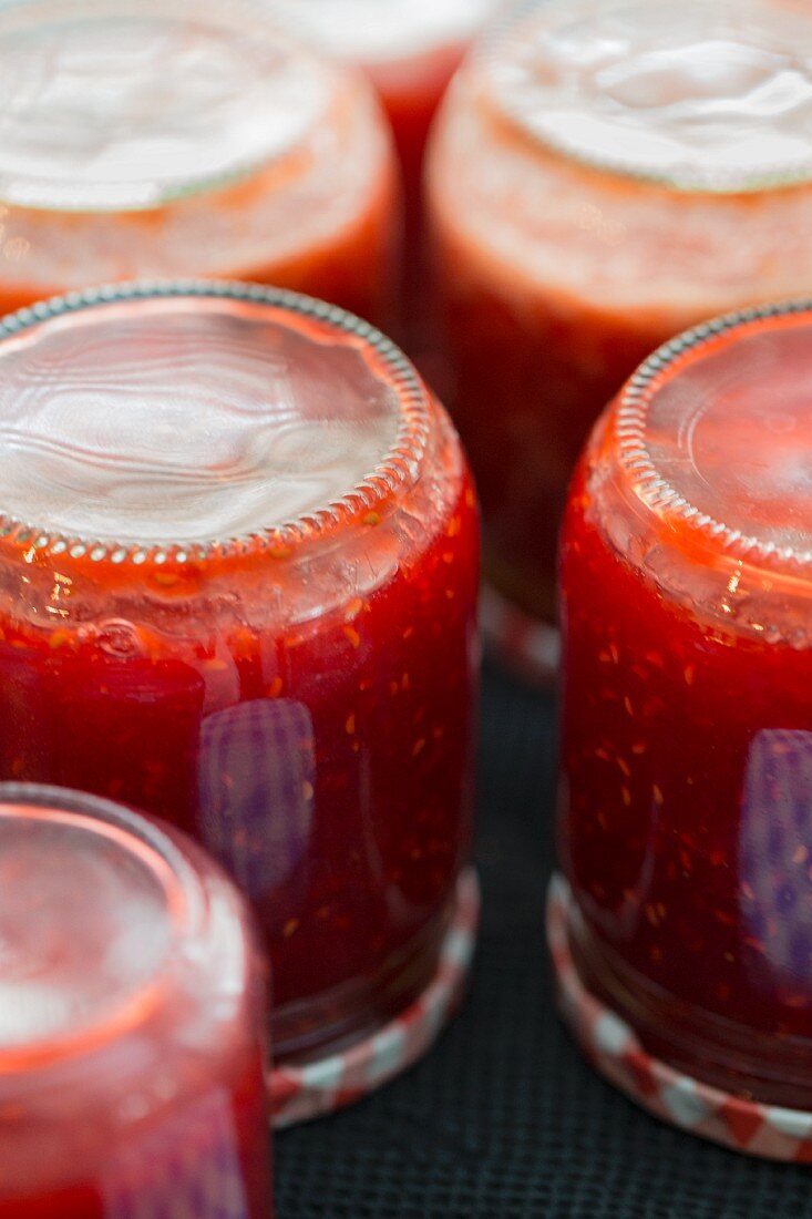 Raspberry jam in upside-down jars