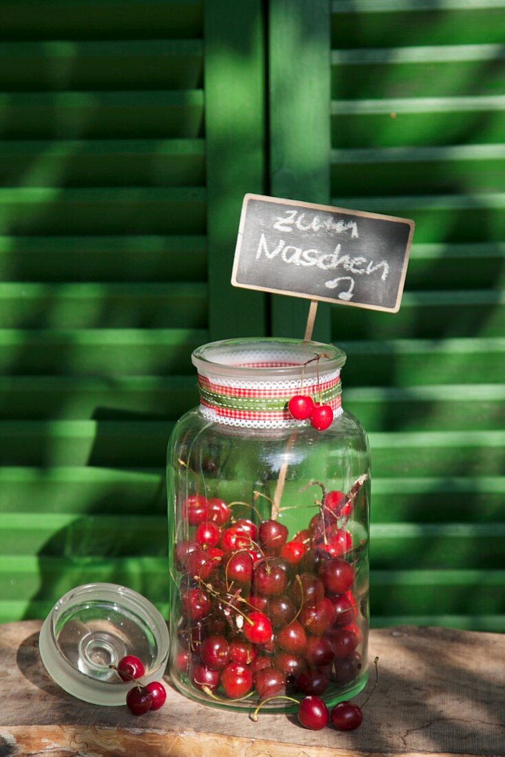 Cherries in sweet jar with chalkboard sign