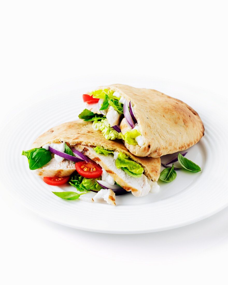 Pita bread filled with chicken, tomatoes and lettuce